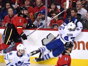 Calgary Flames defenceman Mark Giordano checks Toronto Maple Leafs centre Nazem Kadri during the second period at Scotiabank Saddledome on Feb. 9, 2016. (Candice Ward-USA TODAY Sports)