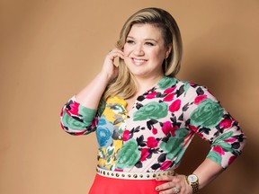 In this March 4, 2015 file photo, American singer and songwriter Kelly Clarkson poses for a portrait to promote her album "Piece by Piece" in New York. Clarkson has written a new song and a bedtime story for kids. "River Rose and the Magical Lullaby," will be released in October by HarperCollins Children's Books. (Photo by Victoria Will/Invision/AP, File)
