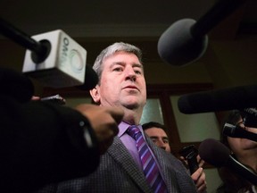 Glen Murray talks to media at Queens Park in Toronto on Thursday, Dec. 12 2013. THE CANADIAN PRESS/Chris Young