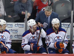 Edmonton Oilers head coach Todd McLellan talks to his players on the bench during the third period of an NHL hockey game against the New Jersey Devils Tuesday, Feb. 9, 2016, in Newark, N.J. The Devils won 2-1. (AP Photo/Mel Evans)
