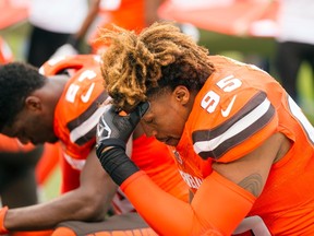 Cleveland Browns linebacker Armonty Bryant (95) kneels for a prayer before a game against the San Francisco 49ers at FirstEnergy Stadium. (Scott R. Galvin/USA TODAY Sports)