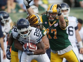 Linebacker JC Sherritt, right, has re-signed with the Edmonton Eskimos.