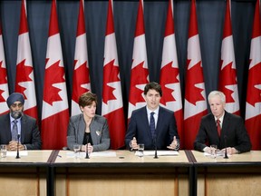 Prime Minister Justin Trudeau (2nd R) speaks during a news conference with Defence Minister Harjit Sajjan  (L), International Development Minister Marie-Claude Bibeau (2nd L) and Foreign Minister Stephane Dion in Ottawa on February 8, 2016. REUTERS/Chris Wattie
