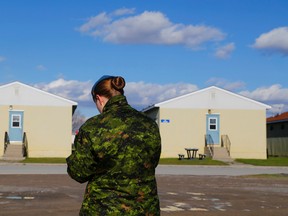 A member of the Canadian Armed Forces stands outside the cadet barracks at CFB Trenton, Ont. Friday, Nov. 20, 2015. (Luke Hendry/Belleville Intelligencer/Postmedia Network)