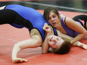 Cora Audette, right, of Confederation Secondary School, attempts to pin Taylor Labelle, of Sudbury Secondary School, during the local high school wrestling championships at Confederation Secondary School in Val Caron, Ont. on Wednesday February 10, 2016. Audette won the 61 kg match. John Lappa/Sudbury Star/Postmedia Network