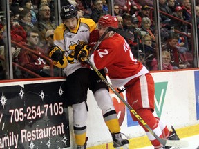 Soo Greyhounds forward Boris Katchouk nails Sarnia Sting forward Jordan Kyrou against the boards during first-period action Wednesday, Feb. 10, 2016 at Essar Centre in Sault Ste. Marie, Ont. Jeffrey Ougler/Sault Star/Postmedia Network