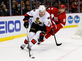 Senators defenceman Dion Phaneuf (2) skates with the puck while being chased by Red Wings left wing Justin Abdelkader (8) during first period NHL action at Joe Louis Arena in Detroit on Wednesday, Feb. 10, 2016. (Rick Osentoski/USA TODAY Sports)