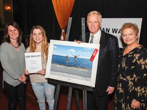 Paige Palmer, second from left, is awarded $700 and has her photo taken with Kingston Life's editor Danielle Vandenbrink and Kingston Accommodation Partners representatives William J Swan and Heather Ford, after her photo was chosen as the overall winner in the Student and Youth Category at the inaugural Ian Walsh Photography Competition award ceremony held in Memorial Hall on Wednesday. (Julia McKay/The Whig-Standard)