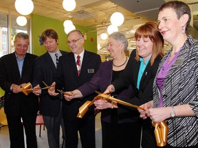 Rudi Denham, third from right, at the official ribbon cutting for the grand re-opening of the St. Thomas Public Library in March of 2012.