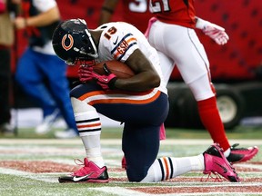 Josh Morgan #19 of the Chicago Bears celebrates after taking this reception in for a touchdown against the Atlanta Falcons at Georgia Dome on October 12, 2014 in Atlanta, Georgia.   Kevin C. Cox/Getty Images/AFP