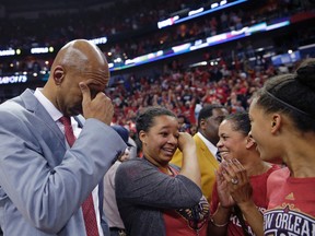 In this April 15, 2015, file photo, New Orleans Pelicans coach Monty Williams reacts after the team's victory in an NBA basketball game against the San Antonio Spurs in New Orleans. Williams' wife, Ingrid Williams, is second from right. Oklahoma City police say Ingrid Williams died Wednesday evening, Feb. 10, 2016, at a hospital. (AP Photo/Gerald Herbert, File)