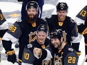 Pacific Division forward John Scott celebrates with his teammates after defeating the Atlantic Division team in the NHL hockey all-star championship game at Bridgestone Arena in Nashville on Jan. 31, 2016. (AP Photo/Mark Zaleski)