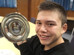 Saimaniq Temela, in Kingston on Thursday, has been part of the sail training program on board the St. Lawrence II since he was 12 and was recently named youth sail trainer of the year by Sail Training International. He is holding the inscribed plate he was awarded. (Michael Lea/The Whig-Standard)