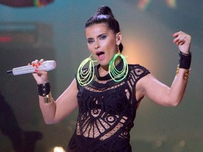 Nelly Furtado performs during the 2012 Much Music Video Awards in Toronto on Sunday, June 17, 2012. Canadian pop star Furtado once sang about "Big Hoops." On Sunday, she'll be singing alongside them as she performs the Canadian national anthem before the NBA All-Star Game in Toronto. THE CANADIAN PRESS/Chris Young