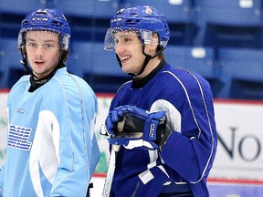 Sudbury Wolves defenceman Cole Mayo, right, chats with teammate Ben Garagan during team practice in Sudbury, Ont. on Thursday February 11, 2016. Gino Donato/Sudbury Star/Postmedia Network