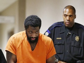 In this Friday, Jan. 8, 2016 file photo, Alton Nolen is led from the courtroom following his preliminary hearing in Norman, Okla. Nolen, accused of beheading a co-worker with a large butcher knife at an Oklahoma food processing plant, was arraigned Thursday for the September 2014 attack at the Vaughan Foods plant in Moore, Okla. (AP Photo/Sue Ogrocki, File)