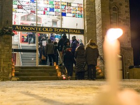 A candle burns outside Almonte Town Hall where about a hundred people showed up to remember Bernard Cameron, a retired high school teacher and town councillor, after he was shot and killed Thursday, Feb. 11, 2016.