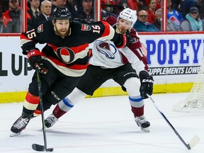 Senators centre Zack Smith (15) fights off the check of Avalanche left wing Blake Comeau (14) during NHL action in Ottawa on Thursday, Feb. 11, 2016. (Errol McGihon/Postmedia)