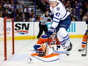 Leo Komarov of the Toronto Maple Leafs jumps out of the way as goalie Cam Talbot makes a save during second period action at Rexall Placethursday. (Topher Seguin)