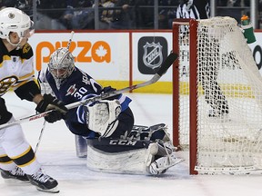 Boston Bruins forward Brad Marchand beats Winnipeg Jets goaltender Connor Hellebuyck with a backhand high on a first-period breakaway in Winnipeg on Thu., Feb. 11, 2016. Kevin King/Winnipeg Sun/Postmedia Network