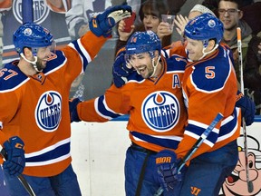 Edmonton Oilers' Benoit Pouliot (67), Jordan Eberle (14) and Mark Fayne (5) celebrate a goal against the Toronto Maple Leafs on the way to a 5-2 win at Rexall Place on Thursday. (Jason Franson)