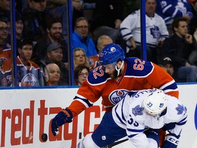 Oilers defenceman Eric Gryba battles maqple Leafs forward Mark Arcobello during Thursday's game at Rexall Place. (Topher Seguin)