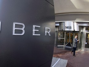 A man leaves the headquarters of Uber in San Francisco on Dec. 16, 2014. An Angus Reid Institute online poll has found that most respondents don't support banning Uber, but would like to see the ride-hailing service regulated like much like the taxi industry. (THE CANADIAN PRESS/AP, Eric Risberg)