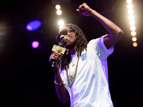 Snoop Dogg performs on the main stage at the Lovebox festival in Victoria Park, London, on July 18, 2015. Marijuana producer Tweed is pairing up with weed-smoking, gin-and-juice sipping Snoop Dogg in a deal that will grant the Ontario-based company exclusive rights to use certain content and brands owned by the rapper's company, LBC Holdings. In exchange for the rights, Tweed will pay Snoop Dogg an undisclosed amount in cash and stock. (THE CANADIAN PRESS/AP/Jonathan Short/Invision)