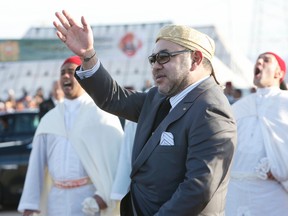 King Mohammed VI of Morocco waves as he inaugurates the solar plant of Ouarzazate, central Morocco, Thursday, Feb.4, 2016. (AP file photo/Abdeljalil Bounhar)