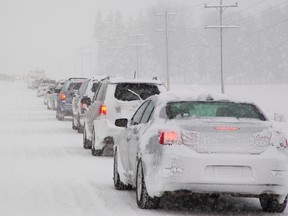 Traffic on Hwy. 4 (Richmond Street) north of London was moving very slowly on Thursday, Feb. 11, 2016, due to heavy snow cover and falling snow. Traffic often stopped due to the poor road conditions which led to vehicles sliding into the ditch. (MIKE HENSEN/The London Free Press/Postmedia Network)