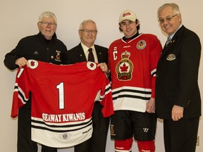 The Sarnia Legionnaires will unveil a 'throwback' third jersey Feb. 18 when the team plays the LaSalle Vipers at the Brock Street barn. Shown here displaying one of the bright red uniforms are Cliff Smith (left) of the Legionnaires executive, Jerry MacPhee, a past president of the Seaway Kiwanis Club (which paid for the jerseys), team captain Hunter Tyczynski and Seaway president Don Burnard. Anne Tigwell photo