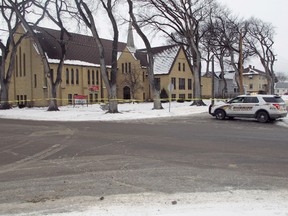 Authorities block off an area in front of Plymouth Congregational Church and near a house in north Fargo, where a suspect fired at police officers during an 11-hour standoff that killed a Fargo police officer. (AP Photo/Dave Kolpack)
