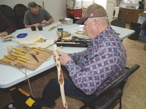 Paige Fossum carves a walking stick out of diamond willow wood during the Stony Plain and District Woodcarvers Club’s gathering on Feb. 8. - Photo by Marcia Love