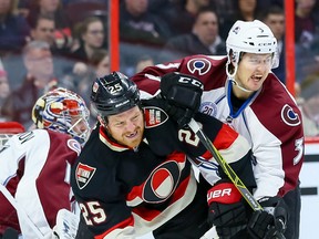 Ottawa Senators right winger Chris Neil battles with Colorado Avalanche defenceman Chris Bigras during NHL action in Ottawa on Feb. 11, 2016. (Errol McGihon/Postmedia)