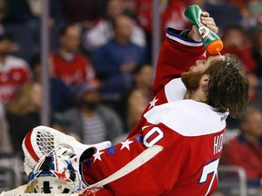 Washington Capitals goalie Braden Holtby squirts water on his head during a stoppage in play against the New York Islanders in the third period at Verizon Center in Washington on Feb. 4, 2016. (Geoff Burke/USA TODAY Sports)