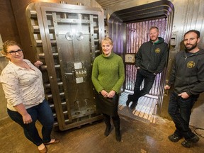 Katie Balmer, from left, and Henriette Riegel, both from the Diefenbunker, with Billy Rogers and Chris Bisson of Escape Manor outside the Vault in the Diefenbunker where Escape Manor, a company that created a popular escape game in Ottawa, will now operate. The game involves players being locked in a room for 45 minutes and having to use their wit and problem-solving skills to escape. The partnership is hoped to improve the game and take advantage of its large space. (Wayne Cuddington/Postmedia Network)