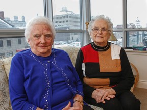 Fraternal twins Lola Gourdier, left, and Lois Halligan, seen here at Gourdier’s apartment in Kingston on Tuesday, will celebrate their 90th birthday on Friday, Feb. 19. The sisters were born on Wolfe Island. (Julia McKay/The Whig-Standard)
