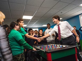 On the 100 day anniversary of his time in office, Prime Minister Justin Trudeau plays foosball with local youth at the Dovercourt Boys and Girls Club before making an announcement to the media about the expansion of the Canada Summer Jobs Program in Toronto on Friday, February 12, 2016. THE CANADIAN PRESS/Aaron Vincent Elkaim