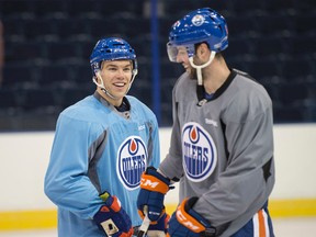 Taylor Hall  shares a laugh with Benoit Pouliot at Edmonton Oilers practice on Friday. The Oilers host the Winnipeg Jets on Saturday (8 p.m.) at Rexall Place.