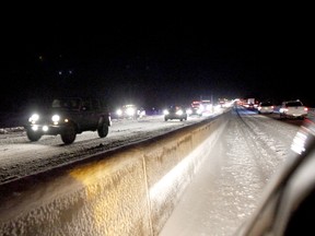 Traffic moves slowly along Highway 401 east of Joyceville Road in the westbound lanes on Friday night following an accident involving four vehicles and a tractor-trailer. Ontario Provincial Police blamed whiteout conditions on the accident. No one was seriously injured and the lanes were reopened by 7 p.m. (Julia McKay/The Whig-Standard)