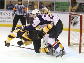 Windsor Spirtfires' Logan Brown flattens Kingston Frontenacs' Spencer Watson during first-period Ontario Hockey League action on Friday at the Rogers K-Rock Centre. (Elliot Ferguson/The Whig-Standard)