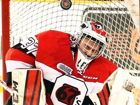 67’s goalie Leo Lazarev deflects a puck out of harm’s way on Feb. 12 at TD Place. (Darren Brown, Postmedia Network)