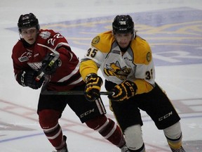 Sarnia Sting forward Nikita Korostelev and Liam Stevens of the Guelph Storm battle for body position during the Ontario Hockey League game at the Sleeman Centre on Friday, Feb. 12, 2016 in Guelph, Ont. Korostelev returned from a five-week absence and scored his 14th goal of the season 8:37 into the game. (Terry Bridge, The Observer)