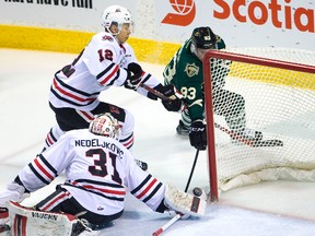 Knights Mitch Marner gets around Niagara goaltender Alex Nedeljkovic and away from the check of Stephen Harper and then tucks the puck over the stick of Nedelikovic to tie the game early in the third period at Budweiser Gardens in London, Ont. on Friday February 12, 2016. Mike Hensen/The London Free Press/Postmedia Network