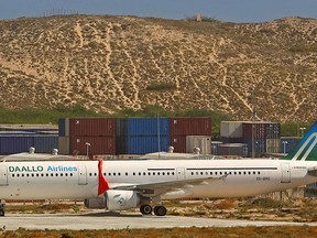 An aircraft belonging to Daallo Airlines is parked at the Aden Abdulle international airport after making an emergency landing following a bomb explosion inside the plane, in Somalia's capital Mogadishu, in this Feb. 3, 2016 file photo. REUTERS/Feisal Omar/Files