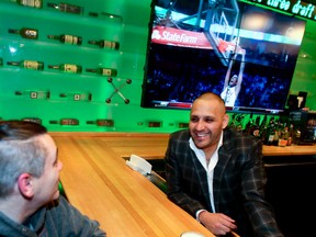 Carlos Gavilanes,(R) General Manager-Owner Operator of Shoeless Joes,  at King & Duncan Sts. chats with a customer on Saturday February 13, 2016. Gavilanes has seen his business improve due to the NBA All-Star weekend. Veronica Henri/Toronto Sun/Postmedia Network