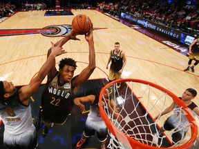 Team World forward Andrew Wiggins dunks the ball past Team United States Jahlil Okafor during second half of the NBA rising stars all-star game in Toronto on Feb. 12, 2016. (THE CANADIAN PRESS/Elsa/Getty Images/Pool)