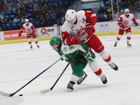 Danny Desrochers, left, of the Sudbury Wolves, attempts to skate around Zach Senyshyn, of the Soo Greyhounds, during OHL action at the Sudbury Community Arena on Saturday night. John Lappa/The Sudbury Star/Postmedia Network