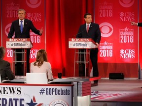 Republican U.S. presidential candidates former Governor Jeb Bush (L) and businessman Donald Trump (R) speak at the same time as they debate the record of Bush's brother, former President George W. Bush, as Senator Ted Cruz (C) looks on at the Republican U.S. presidential candidates debate sponsored by CBS News and the Republican National Committee in Greenville, South Carolina February 13, 2016. REUTERS/Jonathan Ernst