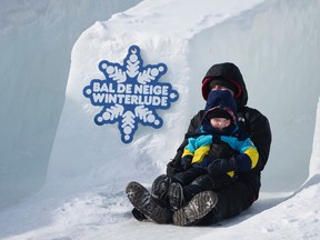 Duff Wray and his son Hank (5) enjoy the slide ride down the hill at Jacques Cartier park during the last weekend of Winterlude on Saturday Feb. 13, 2016. (James Park/Postmedia Network)